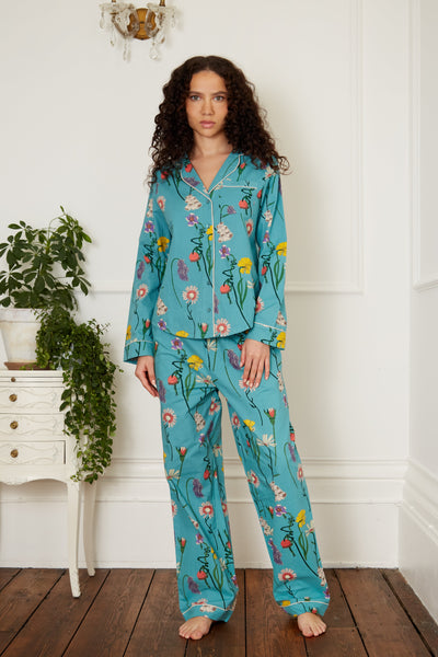 Brunette models wears womens Cotton, full length, shirt and trousers Pjs, Green base with Floral hand drawn pattern