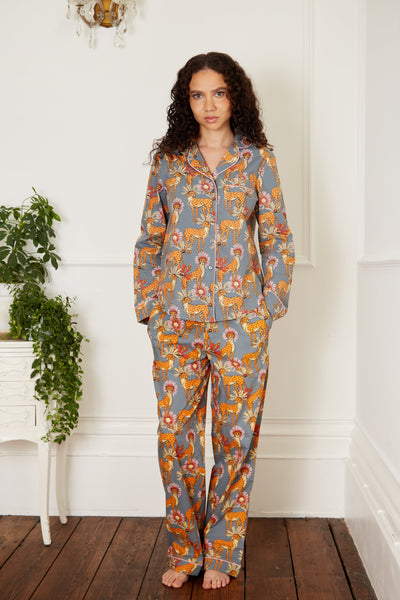 Dark haired model wears womens Cotton, full length, shirt and trousers Pjs, grey base, cheetah with floral detailing pattern