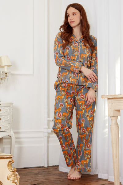 Auburn haired model stands in womens Cotton, full length, shirt and trousers Pjs, grey base, cheetah with floral detailing pattern