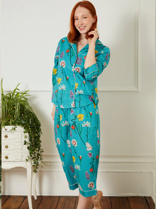 model wears a teal floral capri pyjama set
