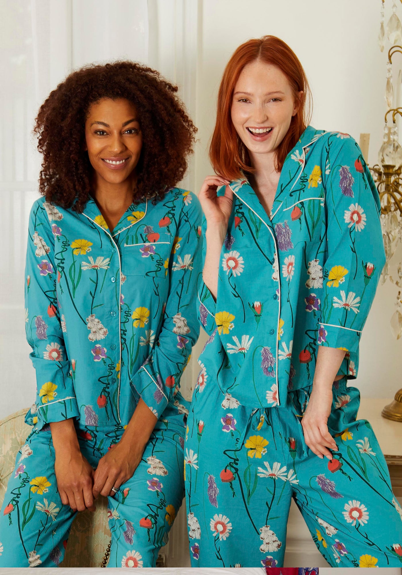 Blonde and Redhead models stand in Cotton, full length, shirt and trousers Pjs, Green base with Floral hand drawn pattern