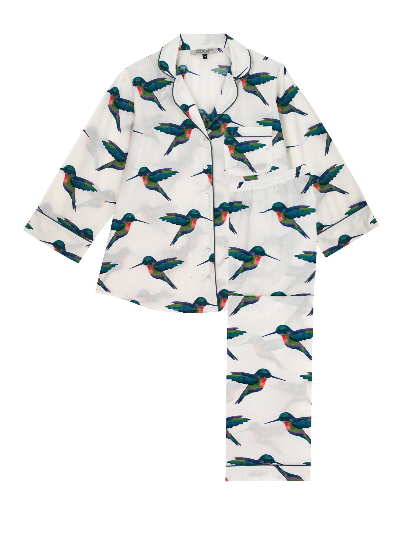 Flat shot of Ladies cotton, shirt and trousers pjs, white base with hand painted hummingbird pattern, navy piping