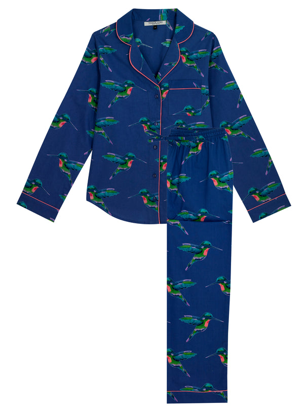 Flat shot of Navy based ladies traditional pyjamas, with repeating hummingbird pattern in alternating directions, pink piping detail on cuffs, sleeves and collar