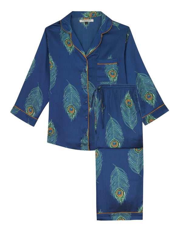 Flat shot of womens satin, shirt and capri trousers pjs, Navy base with hand painted peacock feather pattern with orange piping